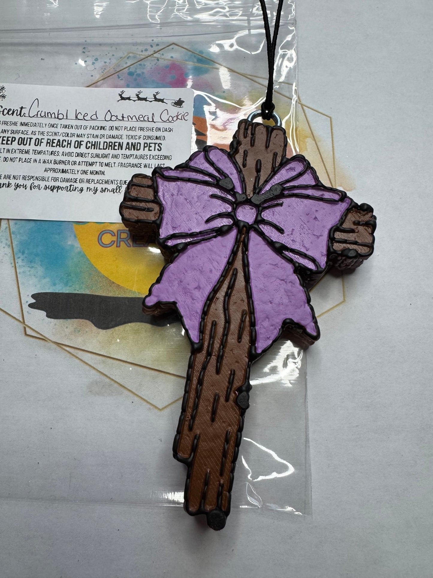 Cross w purple bow... Crumbl Iced Oatmeal Cookie scented || Car Freshie